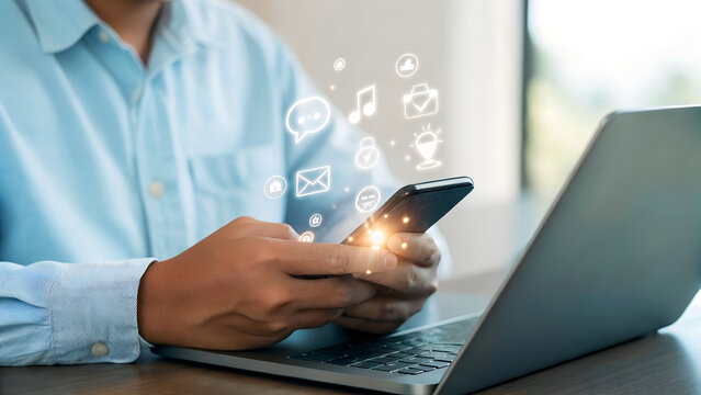 Stay connected easily with glowing social media icons on a phone in a modern workspace, perfect for digital marketing and business growth strategies