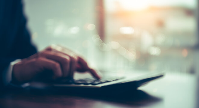 Hands using calculator with financial data overlay business concept blurred background.