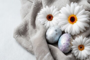 Pastel Easter eggs and daisies on a muted gray cloth
