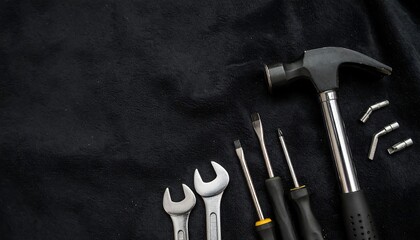 Assorted tools on a dark fabric background