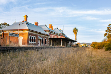 The disused Mudgee Railway Station with tracks overgrown by wild grass