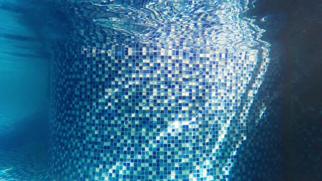 Dynamic water ripple light on the mosaic wall of the swimming pool