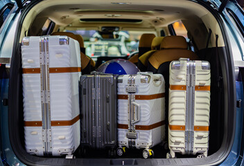 Put your suitcase in the trunk of your car for a holiday trip. © Photo Gallery
