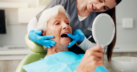 Dentist, senior woman and consulting with mirror for teeth cleaning, dental implant or oral hygiene. Inspection, healthcare or doctor with old patient in clinic for mouth exam or root canal treatment