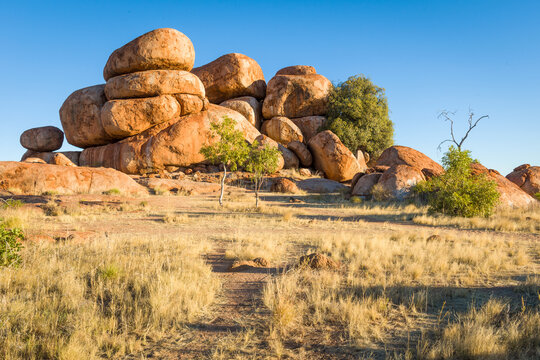 Cluster of giant rounded boulders at Devils Marbles in warm evening light