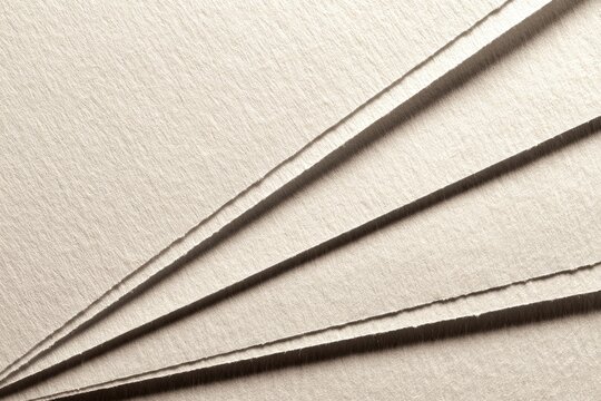 Layered beige paper sheets with creases