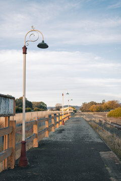 Row of antique lamp posts along platform of abandoned railway station