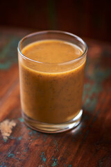 Mango smoothie on wooden background. Soft focus. Copy space.	