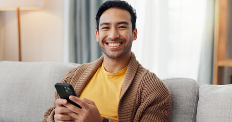 Phone, portrait and relax with happy man on sofa in living room of home for social media scrolling. App, communication and smile with person typing in apartment for internet search or text message