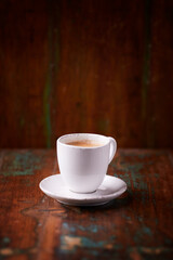 Cup of coffee on rustic wooden background. Soft focus. Copy space	