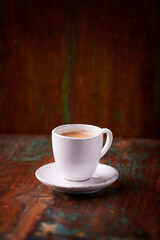 Cup of coffee on rustic wooden background. Soft focus. Copy space	