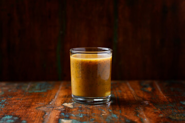Mango smoothie on wooden background. Soft focus. Copy space.	