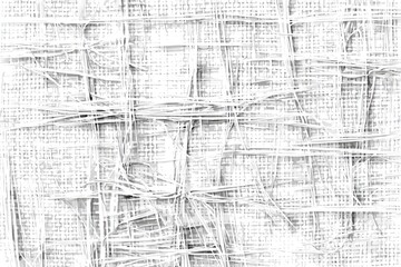 Close-up of a textured white fabric with interwoven threads and frayed edges