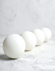 Four white spheres on a light gray surface