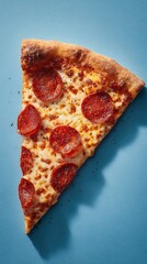 Top view of pepperoni pizza slice on blue textured background
