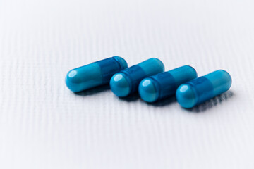 Amino acids capsules on bright background. Soft focus. Close up. Copy space.	