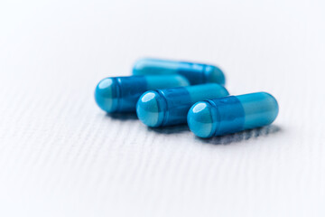 Amino acids capsules on bright background. Soft focus. Close up. Copy space.	