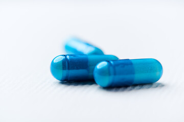 Amino acids capsules on bright background. Soft focus. Close up. Copy space.	