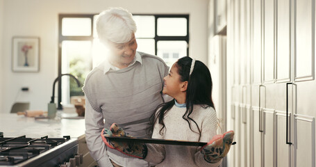 Baking, happy and grandmother with girl with tray for cookies, biscuits and treats in kitchen. Family, dessert and senior woman with child in home for bonding, support and learning recipe together