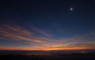 Fototapeta premium Night sky transitioning to dawn over misty mountains (1)