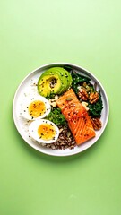 Colorful healthy bowl with salmon, avocado, eggs, and quinoa