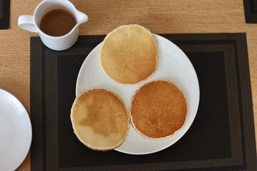Pancake served with maple syrup and whipped cream on top and other garnishing 