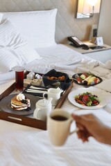 Breakfast on bed of a hotel room showing leisure and comfort
