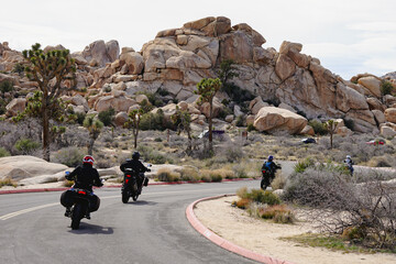 motorcycle ridders on the road in the rock desert hills Joshua Tree