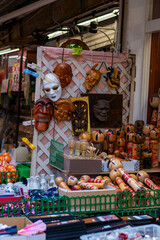 Traditional Japanese masks and kokeshi dolls on display at street market
