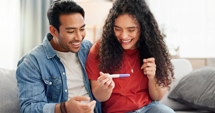 Pregnancy test, happy and couple on sofa excited for fertility success, results and parenting news. Relationship, pregnant and man with woman celebrate with medical kit for ivf treatment or ovulation