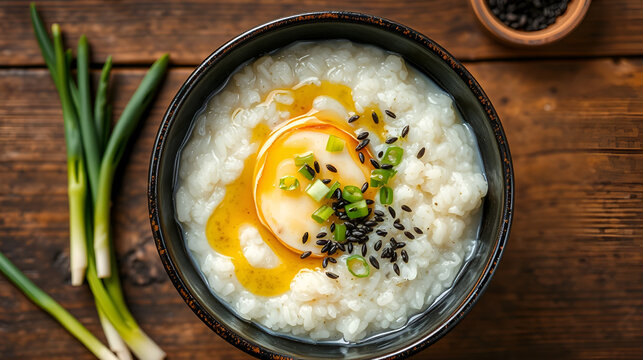 Korean rice porridge juk abalone sesame oil drizzle sliced green onions black sesame garnish rustic bowl top view