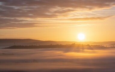 Serene sunrise over foggy hills