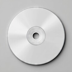 A blank, silver-toned optical disc sits on a light gray background, showcasing a reflective surface and subtle concentric circles around the central hub