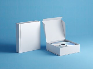 A blank white book and open CD case sit on a light blue background; the case holds a silver disc