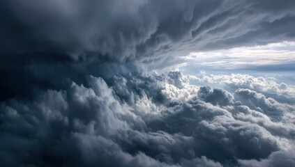 Obraz premium Dramatic storm clouds, a dark ominous cloud mass, with lighter, brighter clouds above and within