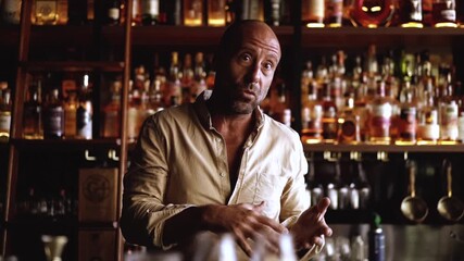 Mexican man talks about mezcal and tequila in a bar, master class