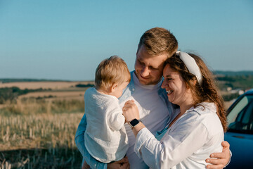 Fototapeta premium Happy family with child outdoors in summer
