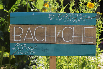 flowers and wooden garden sign