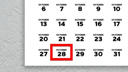 The date October 28th marked with a red cursor on the wall calendar 2025