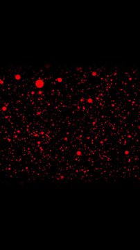 Animated abstract red splatter with textured dots on dark background vertical video. Abstract red dots splatter against black background for artistic textures and effects.