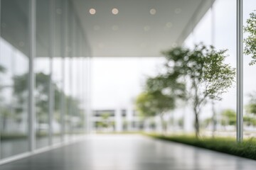 An abstract architectural shot shows a blurred walkway lined with glass walls and trees, leading towards a bright, undefined outdoor space