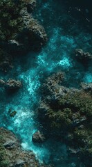 Fototapeta premium Aerial shot of a turquoise-toned river flowing between rocky, green banks. Sunlight reflects off water, creating a shimmering, ethereal feel