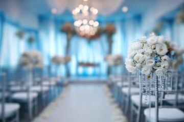 An aisle of silver chairs leads to an arch adorned with flowers in a room decorated with light blue drapes, creating an elegant ambiance