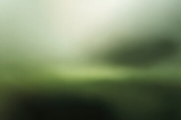 Obraz premium A hazy, soft-focus image with gradients of green, black, and light grey. The image suggests a dreamy landscape or nature scene, ethereal & muted
