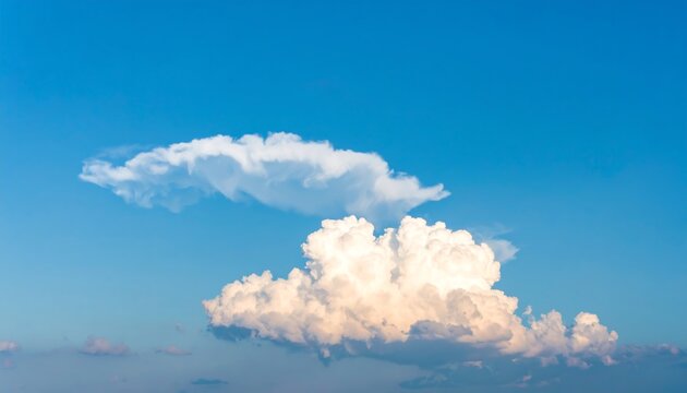 Fluffy white clouds drifting in a clear blue sky