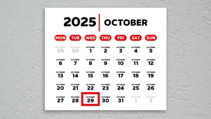 The date October 29th marked with a red cursor on the wall calendar 2025