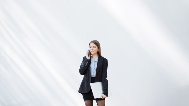 Businesswoman talk on mobile phone at white background