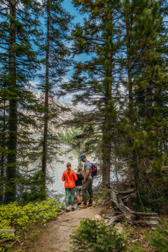 Family Hiking Next to Lake with Mountains