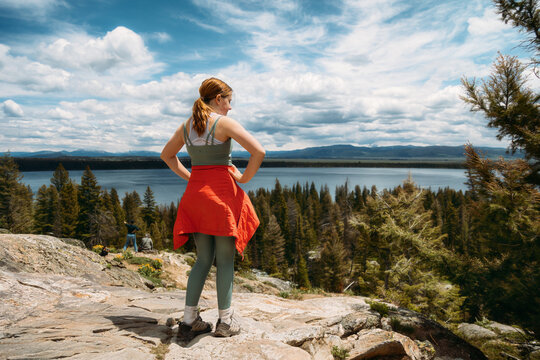 Girl Standing on Mountain Side Looking at View