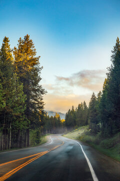 Morning Fog on Curvy Road with Mountain Backdrop